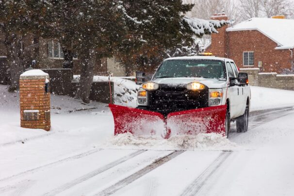 Snow Removal Management Professional snow removal truck clearing a commercial lot in Fort Collins